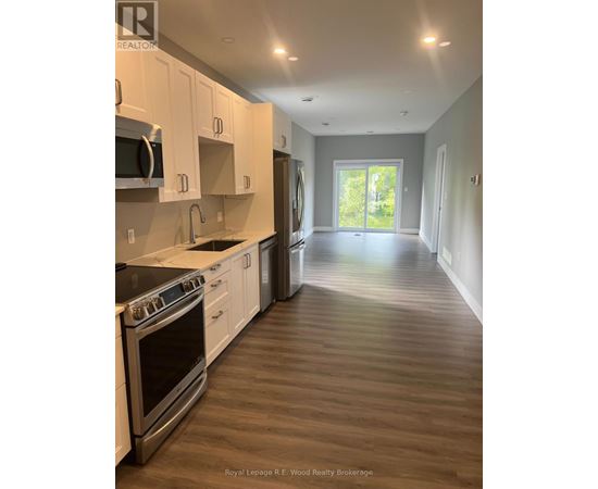 A kitchen with white cabinets and stainless steel appliances.