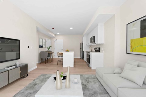 A modern living room with a white couch and a grey rug.