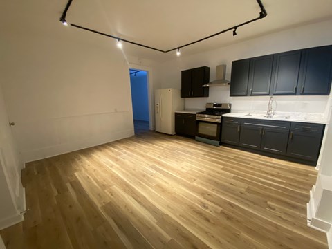 A kitchen with dark cabinets and a blue door.