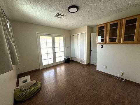 A room with a green chair and a white wall.