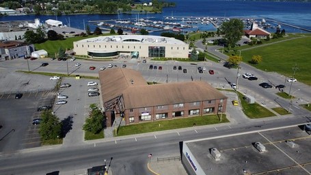 A parking lot with cars and a building in the background.