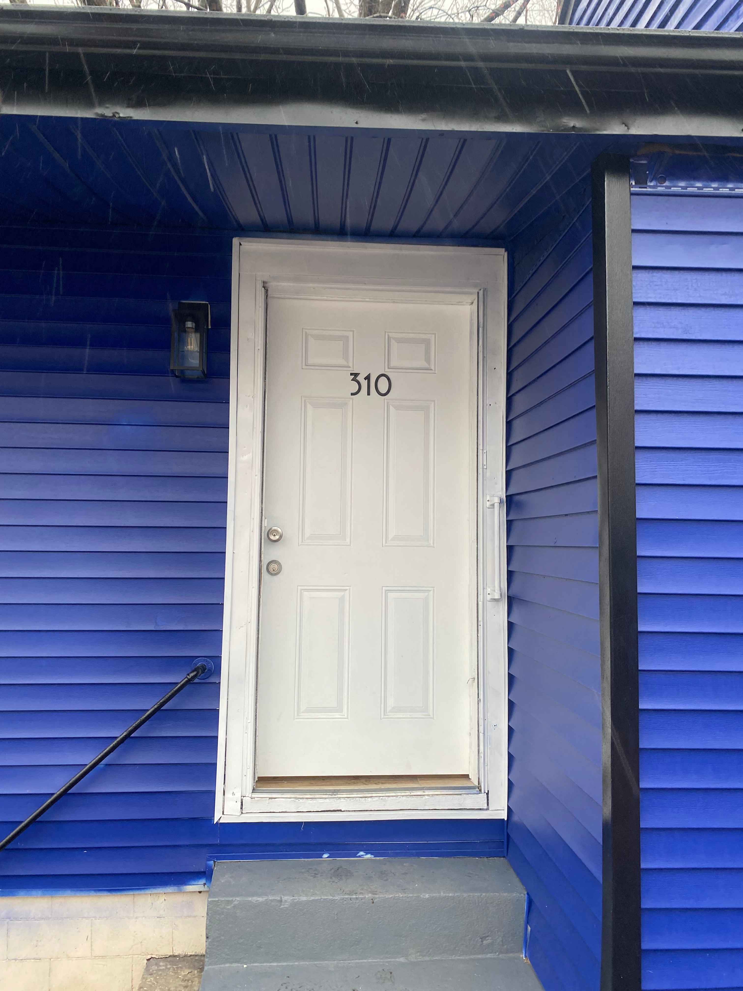 A white door with the number 310 on it.