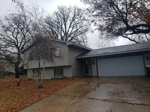 A house with a grey roof and a grey garage door.