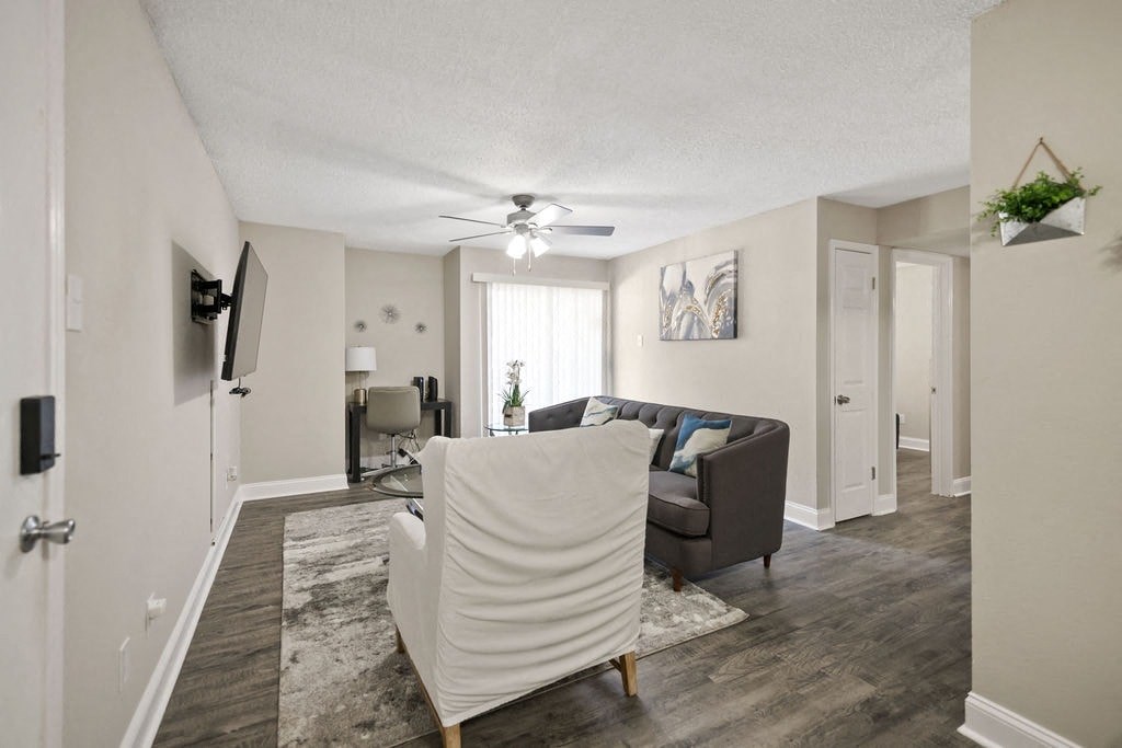 A living room with a white sofa and a grey couch.