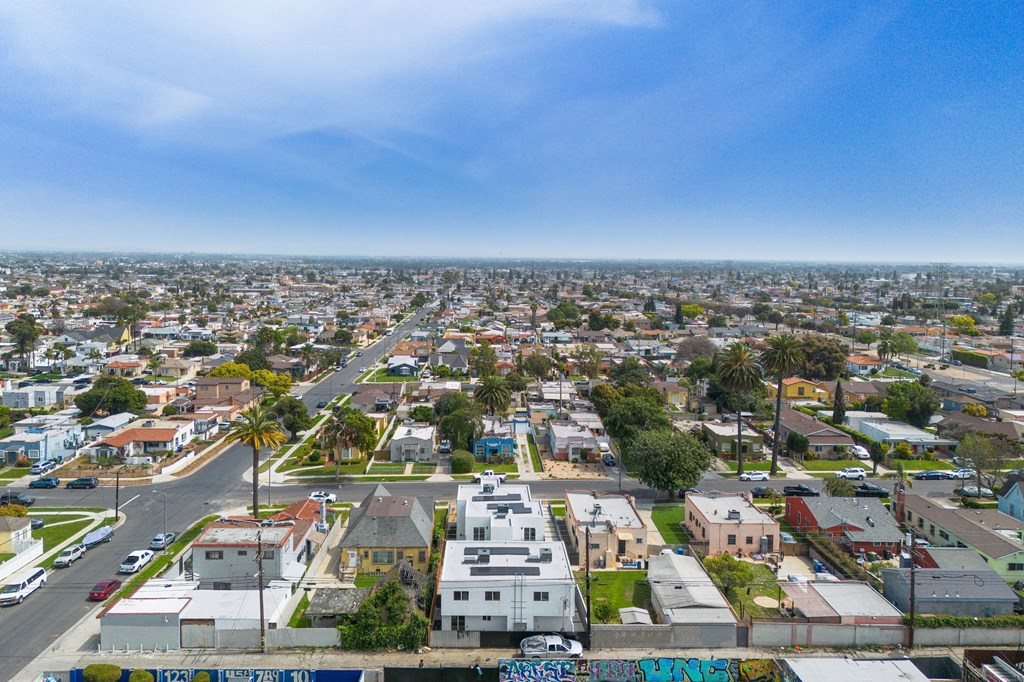 A cityscape with buildings and streets under a clear sky.