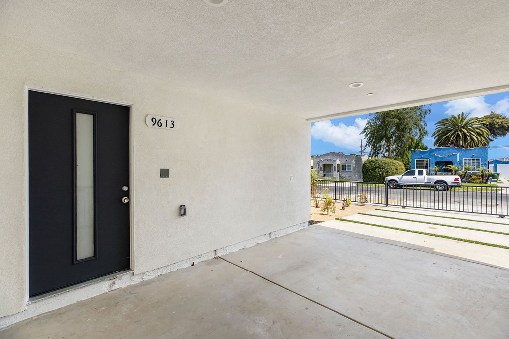 A black door with the number 9613 on the wall above it.