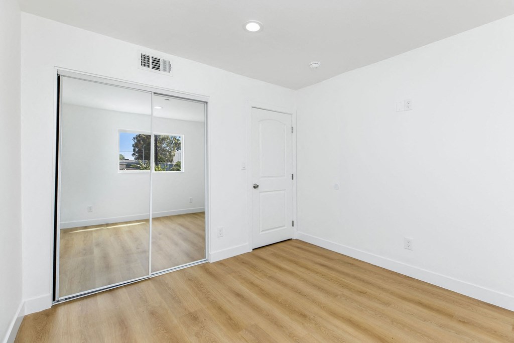 A room with a white door and a glass door.