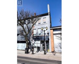 A street view of a building with a Realty sign on it.