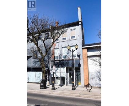 A street view of a building with a Realty sign on it.