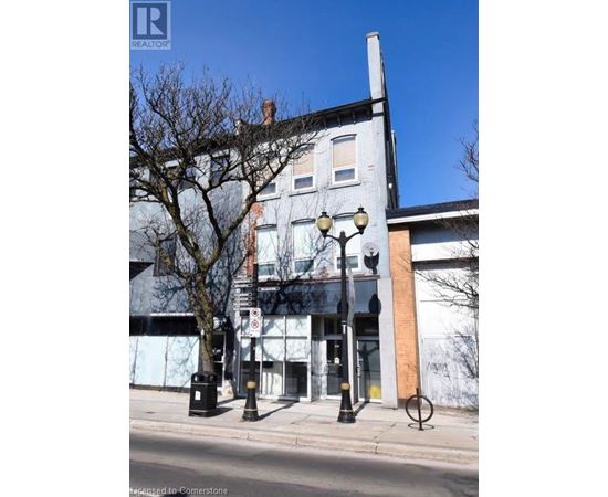 A street view of a building with a Realty sign on it.