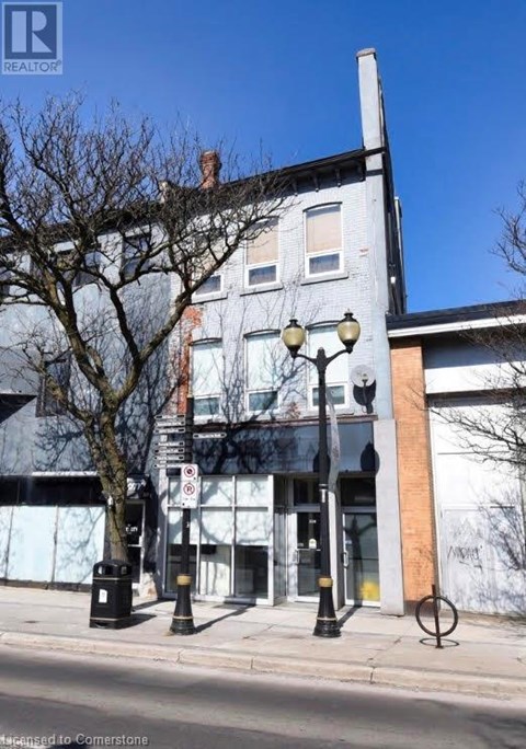 A street view of a building with a Realty sign on it.