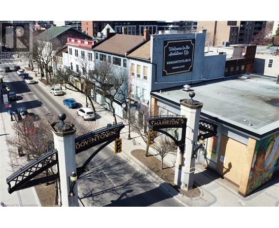 A street view of a downtown area with a sign that reads "Hamilton.".