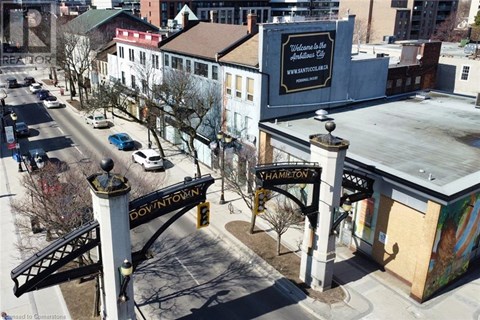 A street view of a downtown area with a sign that reads "Hamilton.".