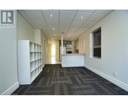 A long hallway with a carpeted floor and white walls.