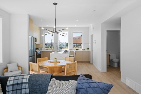A modern living room with a dining table and chairs.