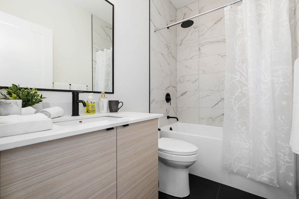 A white toilet sits next to a sink in a bathroom.
