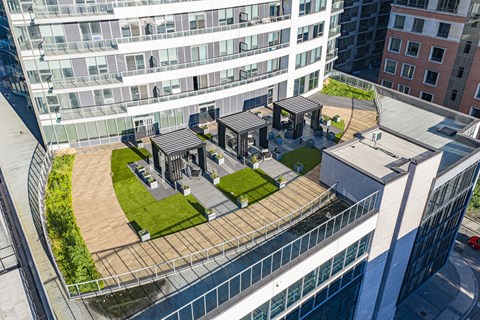 A modern building with a green space in the middle.