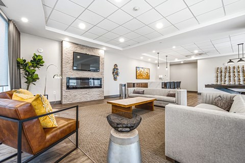 A modern living room with a fireplace and a flat screen TV.