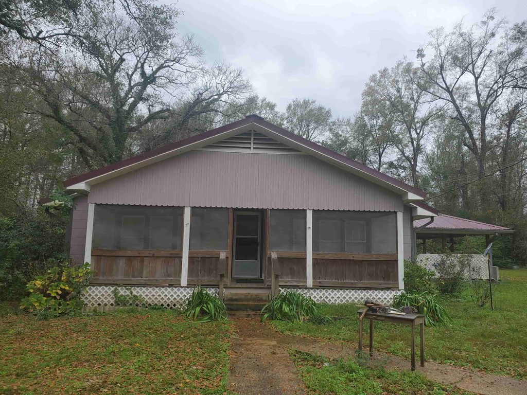A house with a brown roof and a white fence.