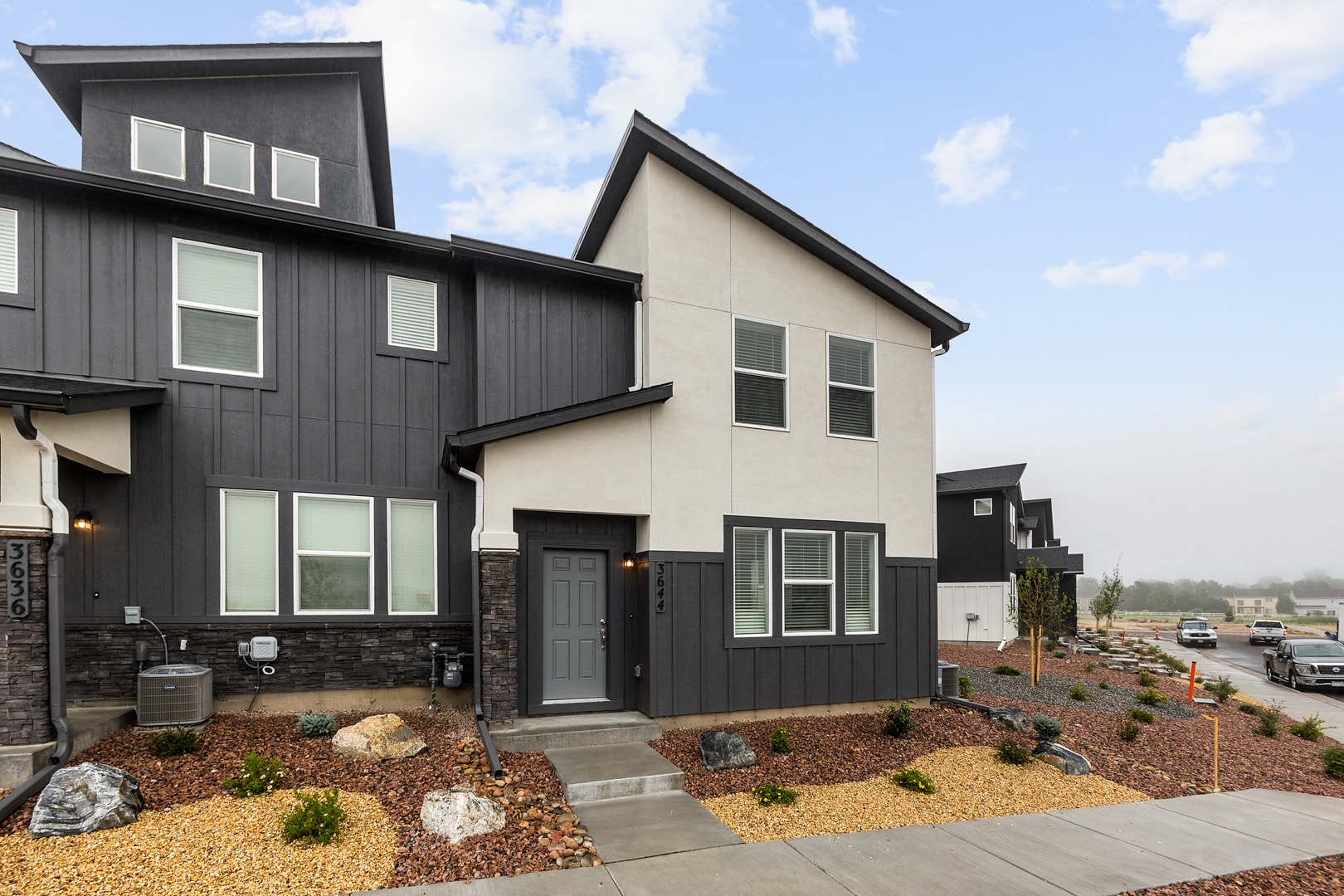 A modern two-story house with a black and white exterior.