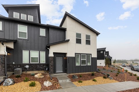 A modern two-story house with a black and white exterior.