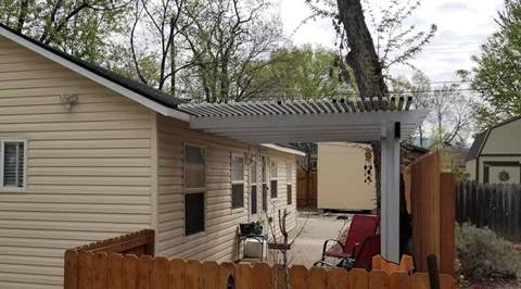 A house with a wooden fence and a patio area.