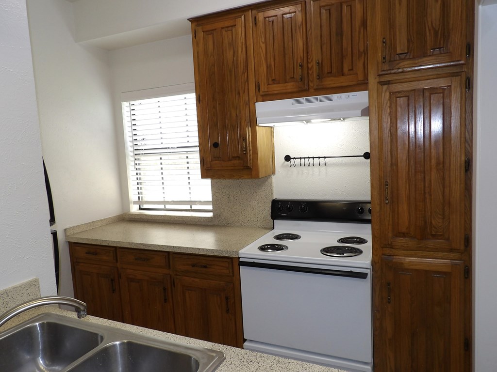 A kitchen with a stove and a sink.