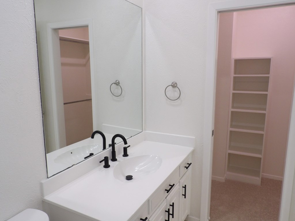 A white bathroom sink with a mirror above it.