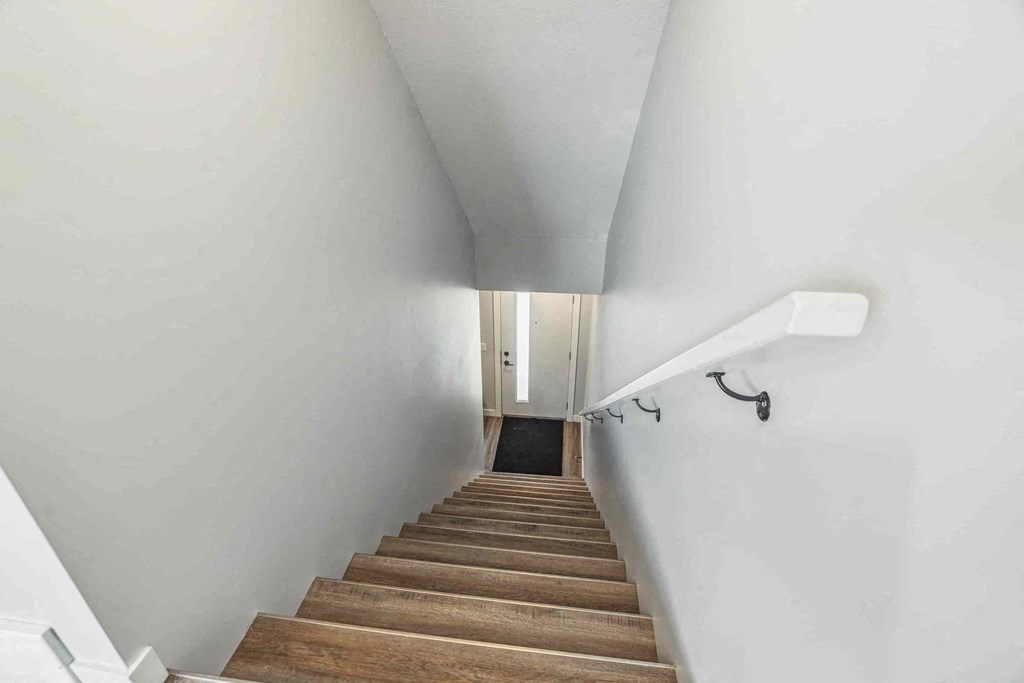 A staircase with wooden steps and white railings.