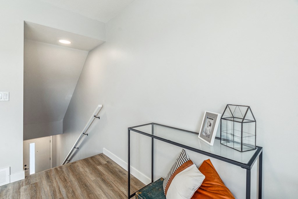 A room with a black metal table and a picture frame on it.