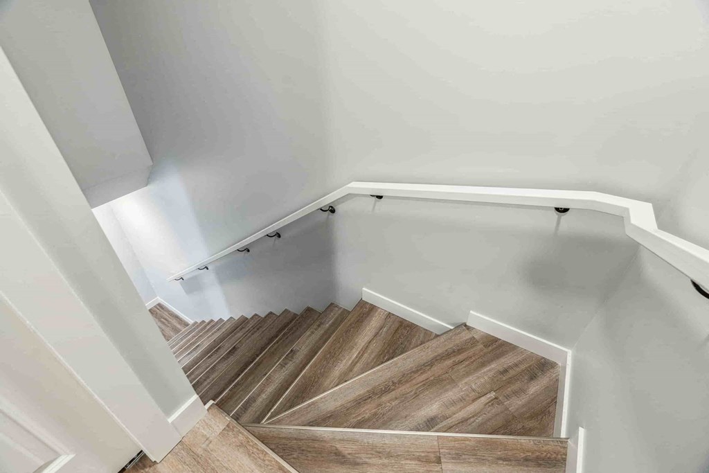 A staircase with wooden steps and white railings.