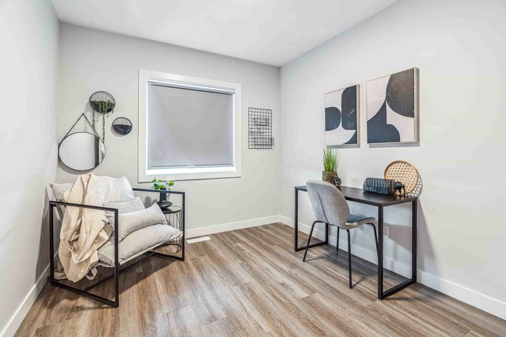 A room with a chair, a table, and a couch.