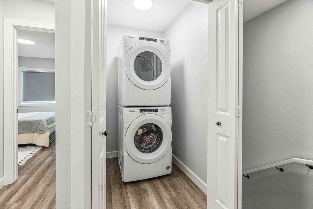 A white washing machine and dryer in a small laundry room.