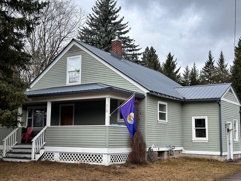 A house with a flag on the porch.
