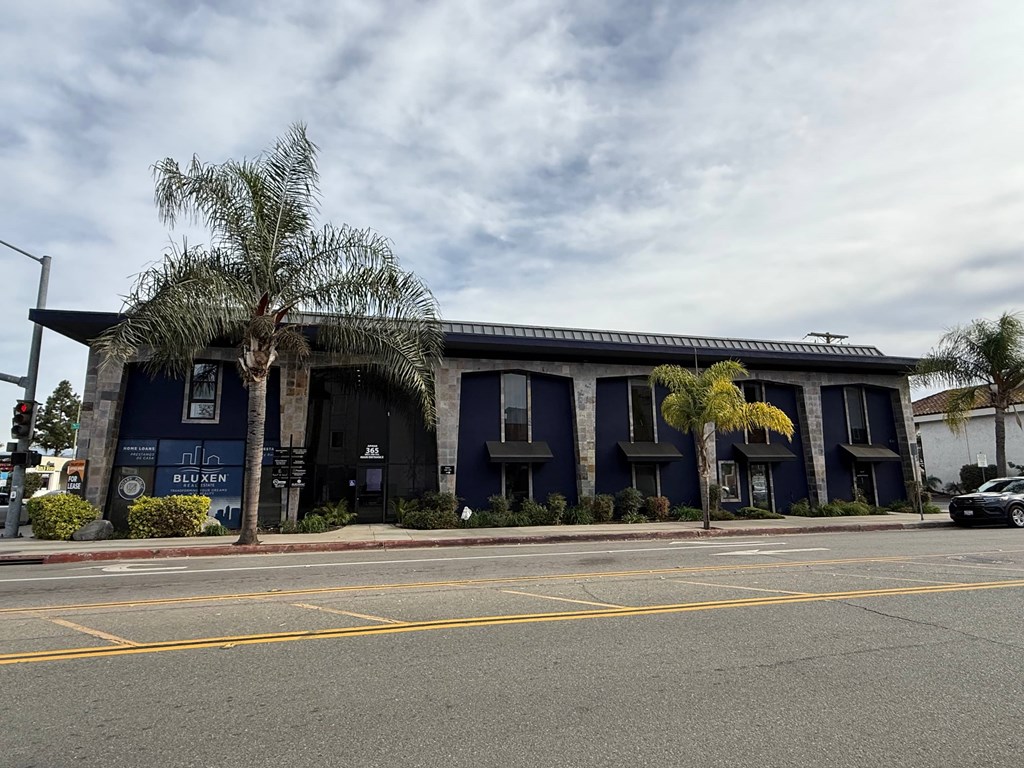 A blue building with a sign that says "BLUXEN" on it.