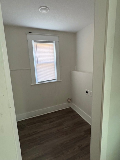 A room with a window and wooden flooring.