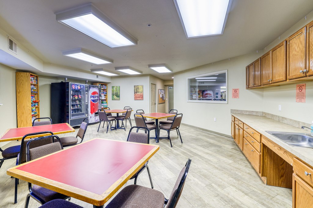 A kitchen with a table and chairs in the middle of the room.