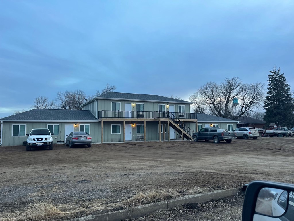 A house with a car parked in front of it.