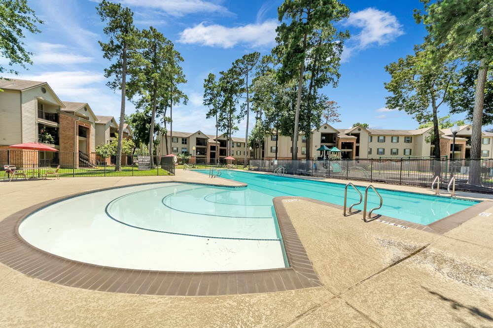 A swimming pool surrounded by apartment buildings.