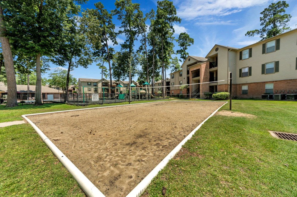 A sandbox in front of apartment buildings.