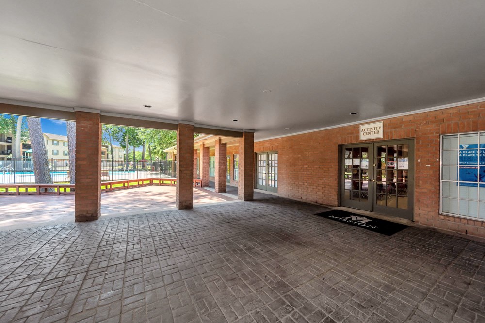 A brick building with a glass door and a sign that says "CENTER".