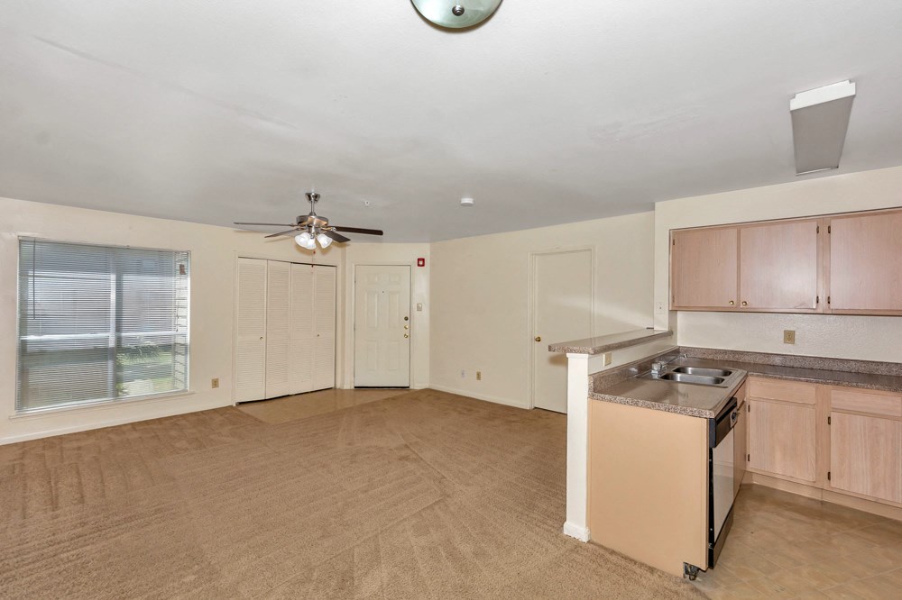A kitchen with a fan and a window.