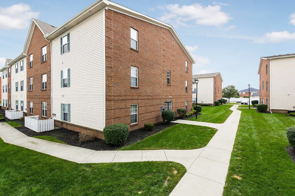 A living room with a couch, chairs, and a coffee table.
