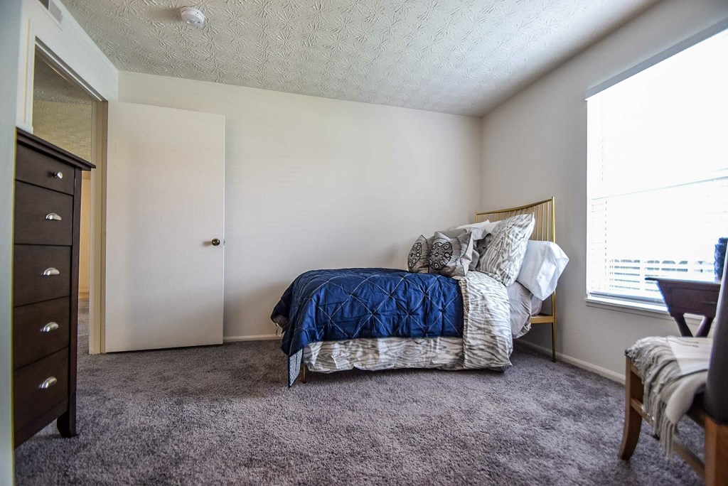 A white toilet sits in a bathroom next to a glass shower door.