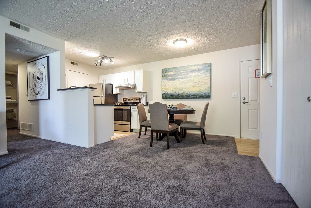 A bedroom with a bed, dresser, and window.