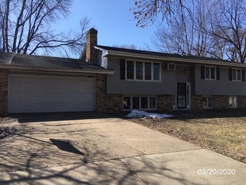 A house with a garage and a driveway.