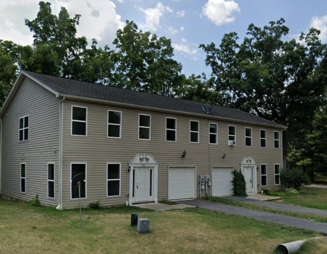 A two-story house with a garage on the side.