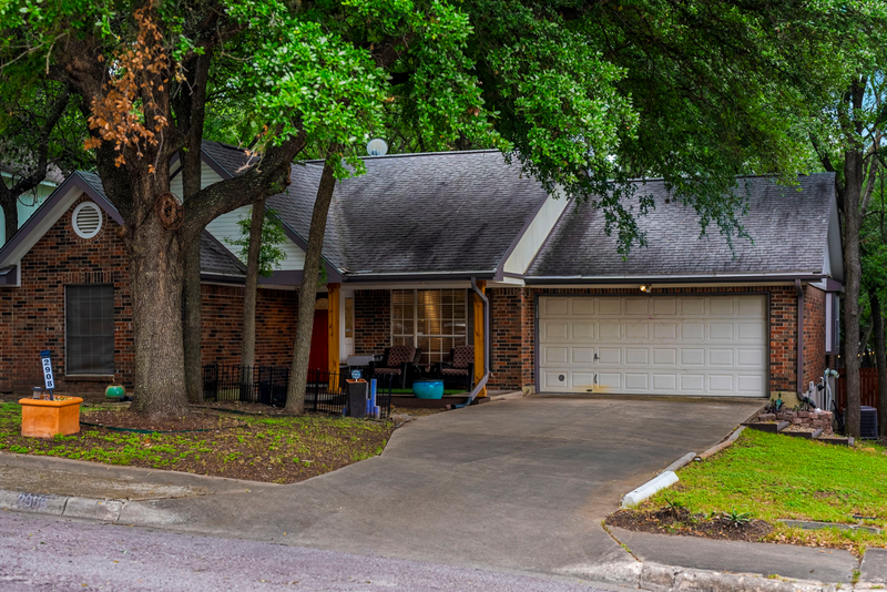 A house with a garage and a driveway.