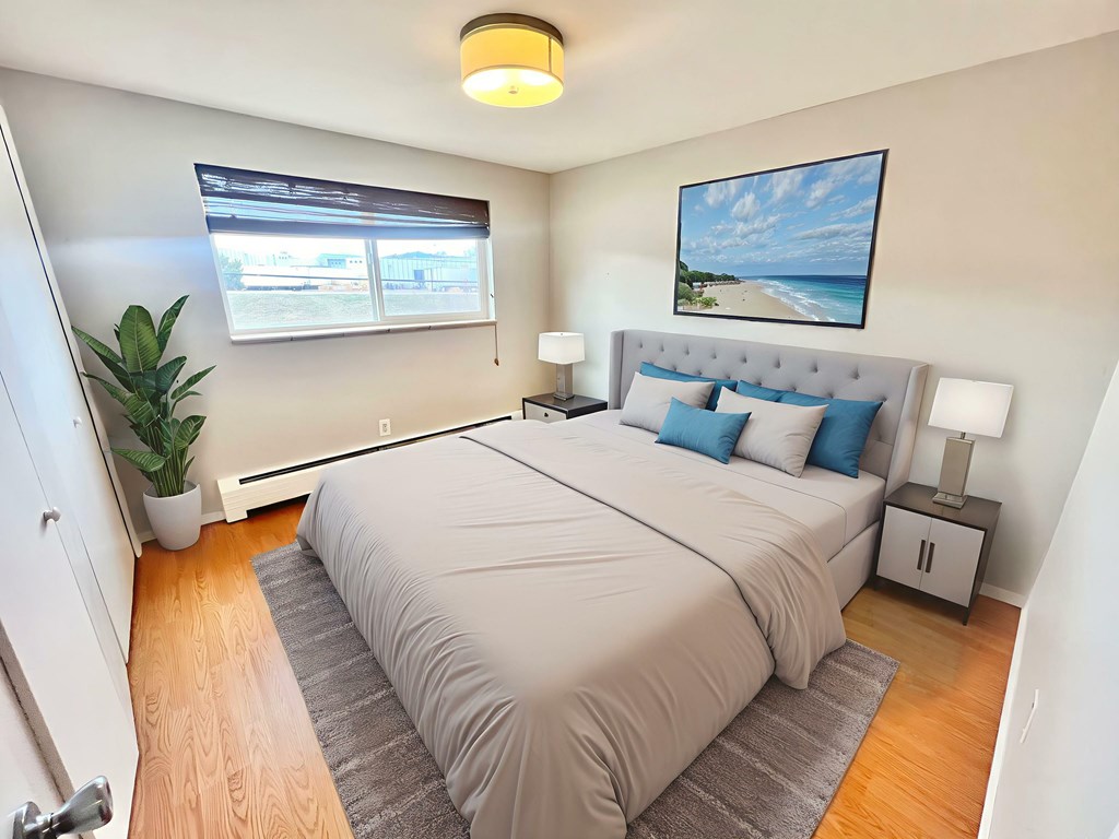 A tree with yellow leaves is in front of a house.