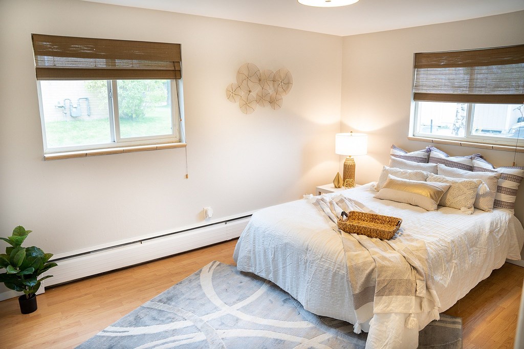 A bedroom with a large bed and a plant.